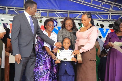 The Katikkiro, together with Hon. Cotilda Nakate Kikomeko and his wife, appreciating learners who have completed the nursery level. The Katikkiro, together with Hon. Cotilda Nakate Kikomeko and his wife, appreciating learners who have completed the nursery level.